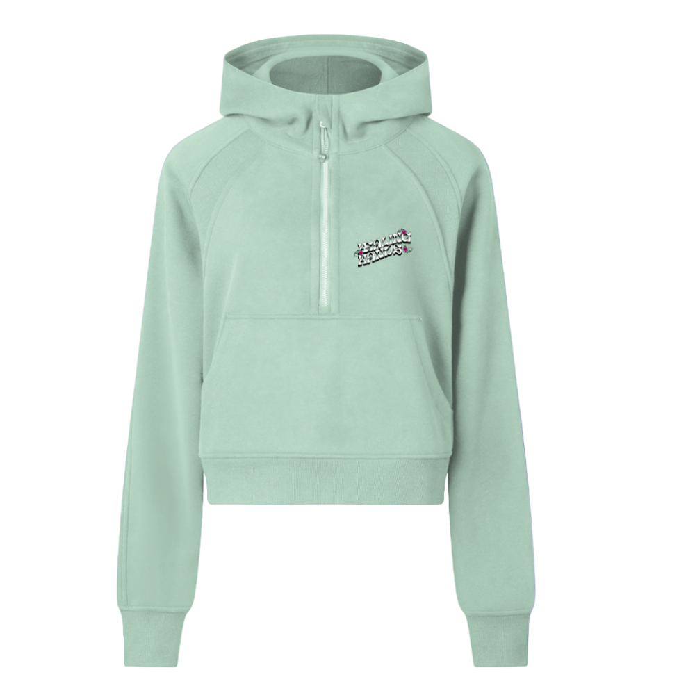 Front view of the women’s cropped half-zip bodycon hoodie featuring the “Healing Hands” graphic on the chest. Shows the long raglan sleeves, zipper detail, and fitted cropped silhouette. Green