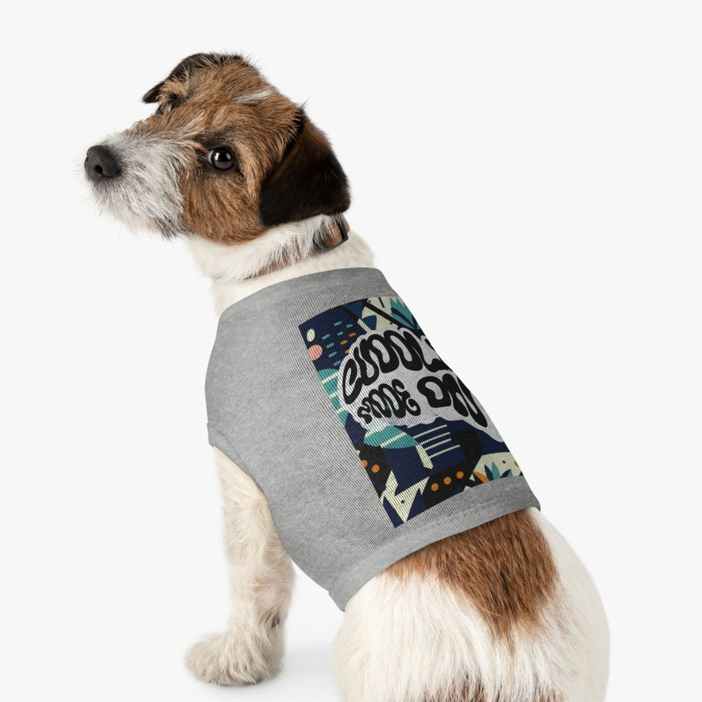 Dog wearing a gray sweater with colorful graphic design on a white background