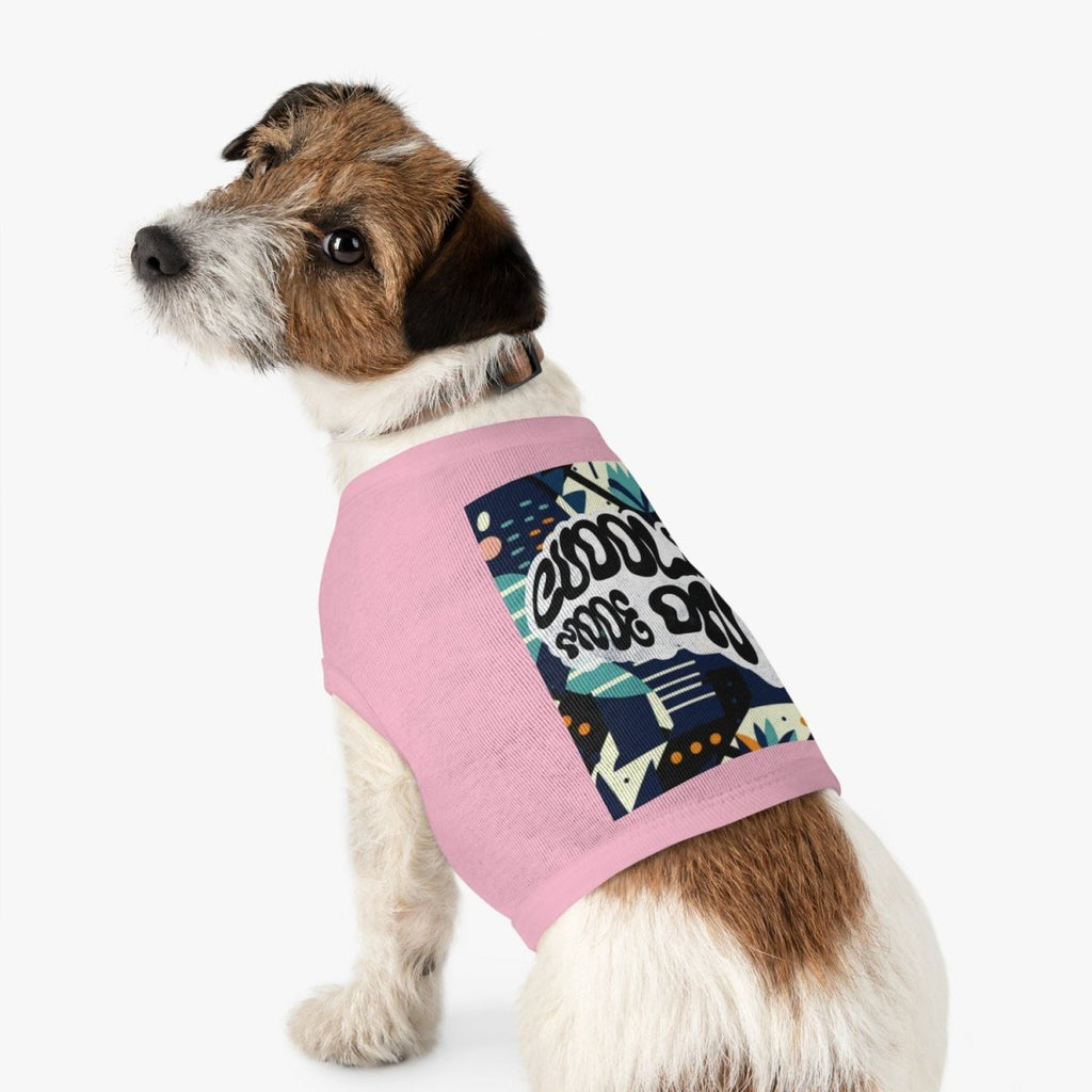 Dog wearing a pink sweater with graphic design on a white background
