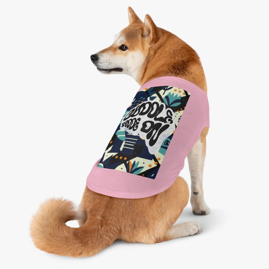 Dog wearing a colorful patterned shirt with pink trim on a white background
