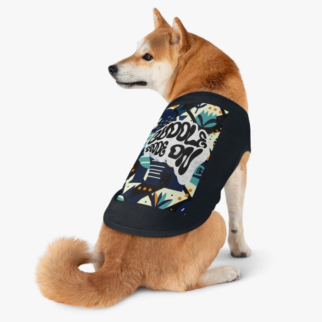 Dog wearing a black shirt with colorful design on a white background