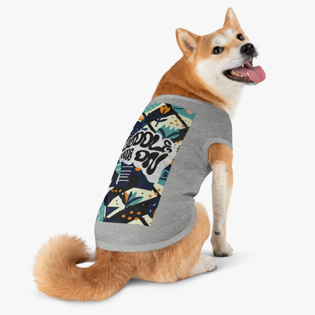 Dog wearing gray shirt with colorful patterned shirt on a white background