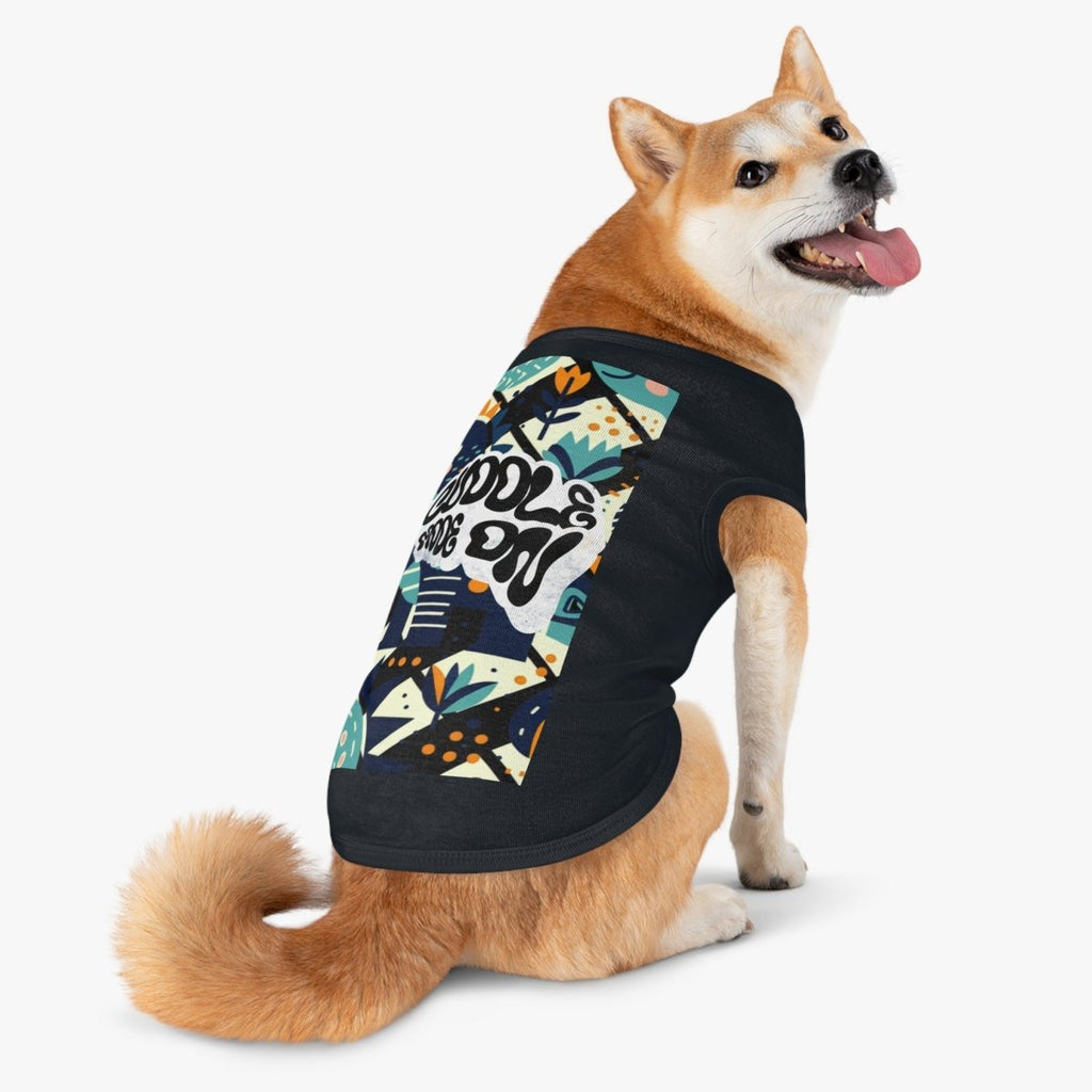 Dog wearing a black t-shirt with colorful geometric pattern and text on a white background
