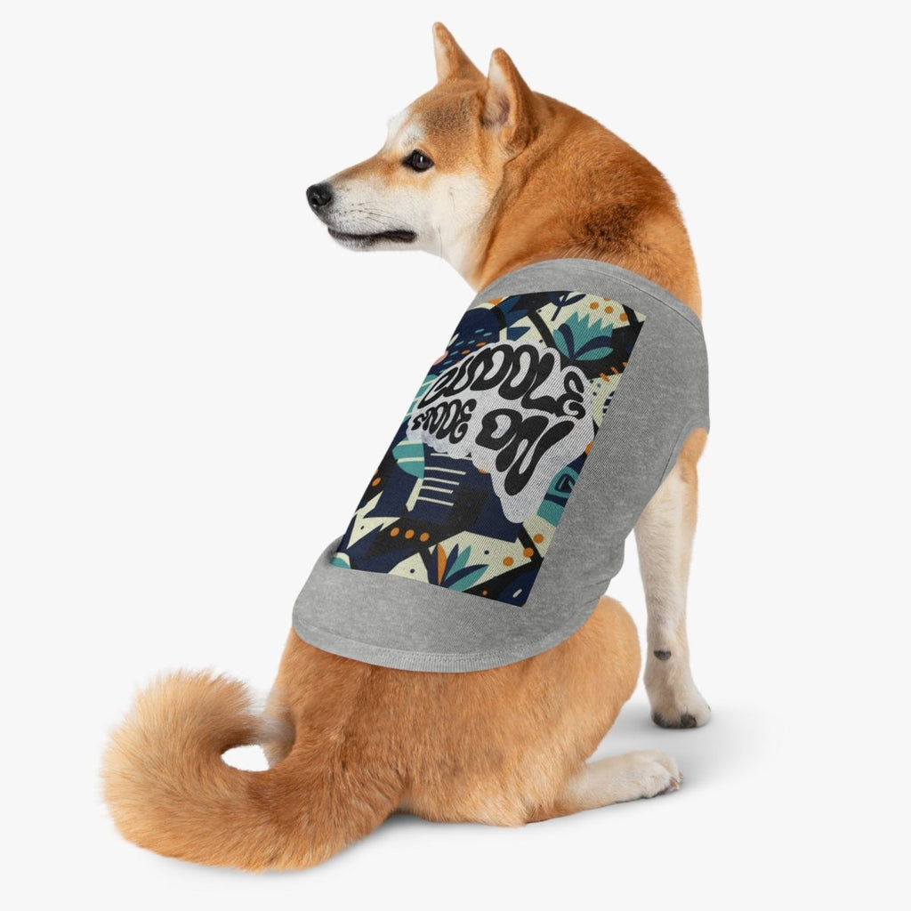 Dog wearing a gray tank top with a colorful graphic design on a white background