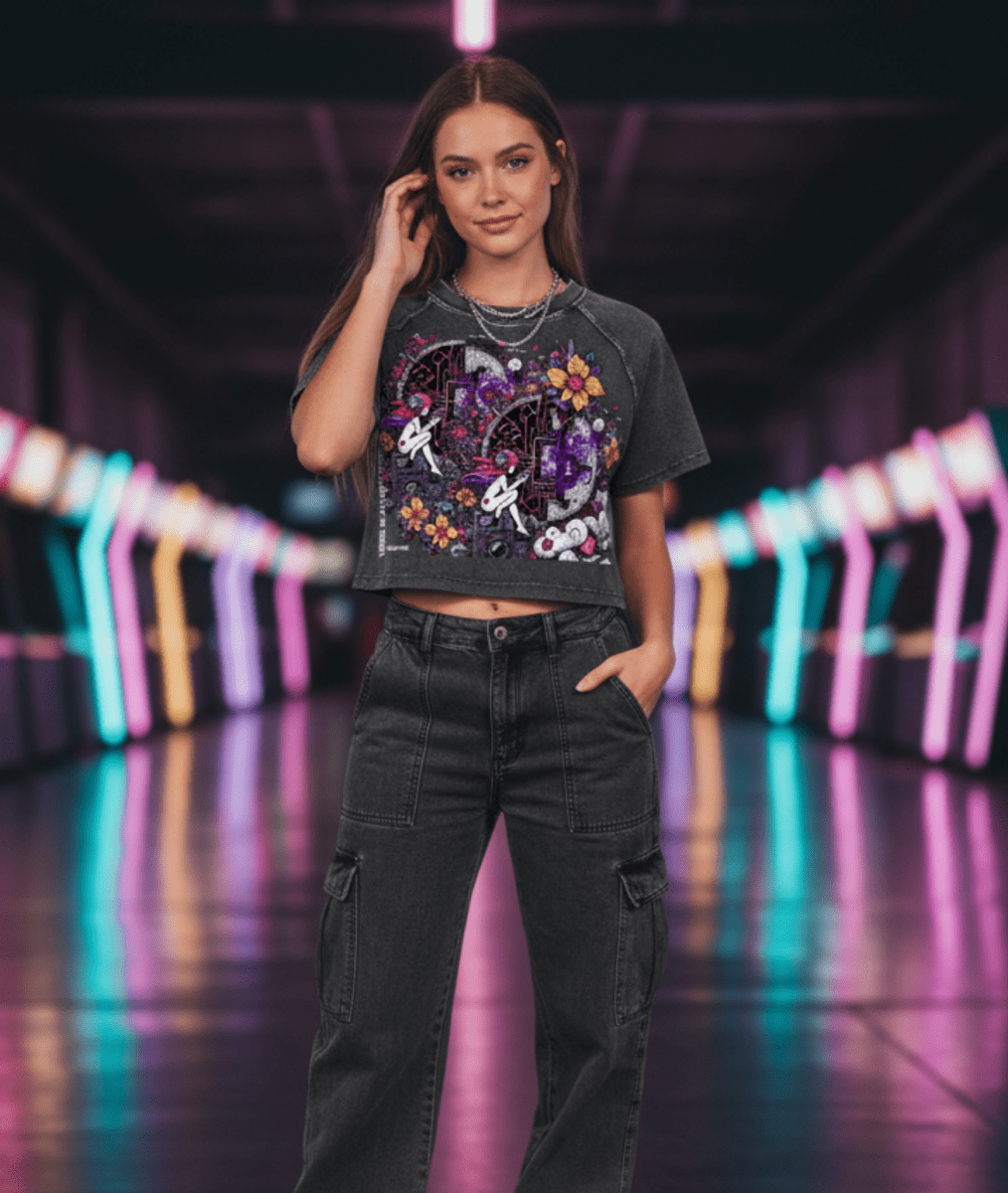 Woman in a dark outfit with floral design standing in a futuristic, neon-lit corridor.