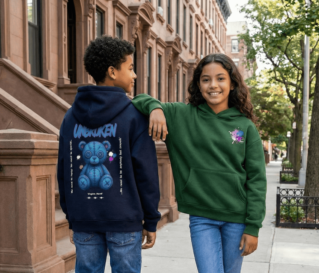 Two children wearing hoodies with colorful designs on a city street.